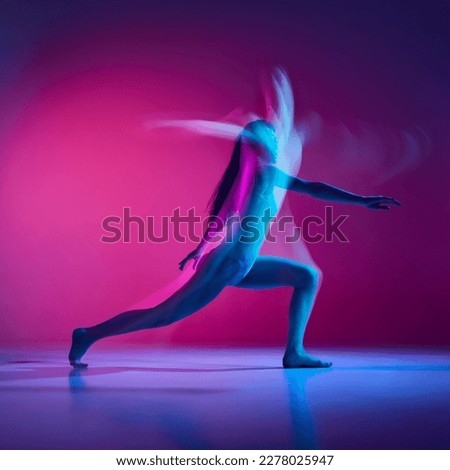 Expressive contemp. Young woman dancing in bodysuit over gradient pink studio background in neon with mixed lights. Concept of contemporary dance style, art, aesthetics, hobby, creative lifestyle