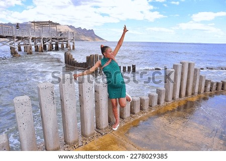 happy black pregnant woman on the beach