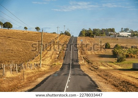 Across the Queensland countryside, straight road up to the hill - Australia.