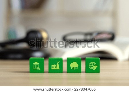 The environmental law or politician with nature and environment-friendly values. Green wooden cubes with a decarbonization icon and green icon.Sustainable development.global warming and conservation. Royalty-Free Stock Photo #2278047055