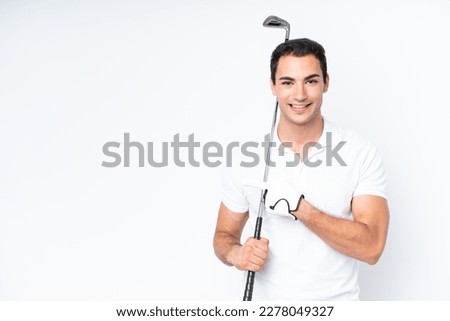 Young caucasian man isolated on white background playing golf and pointing to the lateral