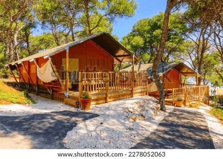 Stunning glamping with teepee camping tents in a wooded area. Location place Croatia, Europe. Photo of popular travel destination. The concept of ecological recreation. Discover the beauty of earth. Royalty-Free Stock Photo #2278052063
