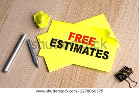 FREE ESTIMATES text on a yellow sticky on wooden background
