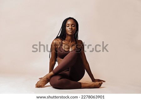 woman in lotus pose yoga studio portrait Royalty-Free Stock Photo #2278063901