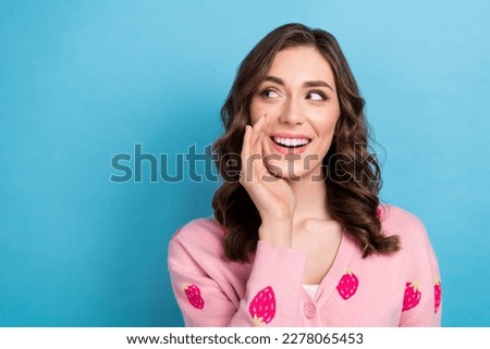 Photo of tricky dreamy woman wear pink cardigan arm mouth looking emtpy space isolated blue color background