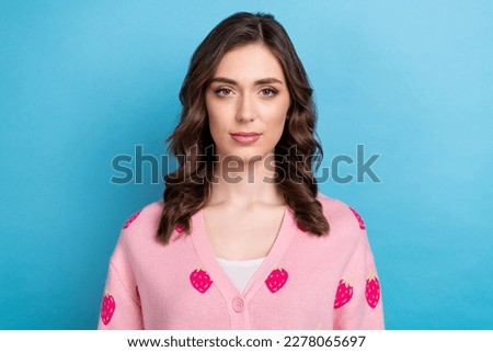 Portrait photo of charming confident serious lady wear stylish pink strawberry print cardigan satisfied her weekend isolated on blue color background