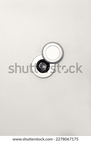 peephole on a white door with copy space for your text Royalty-Free Stock Photo #2278067175