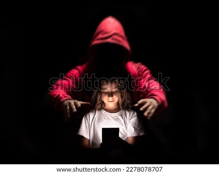 A girl using her cell phone on social networks without being aware of the dangers they can have. Royalty-Free Stock Photo #2278078707