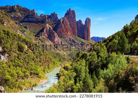 The picturesque river Gallego flows through the gorge. Beautiful rocks - part of the foothills of the Pyrenees. The magnificent Mallets of Riglos. Romantic trip to Spain. Aragon. 