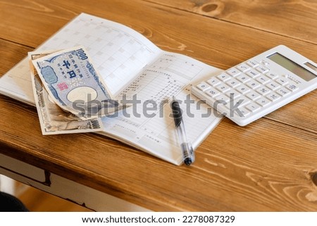 Household accounts book and saving money. Calculating personal finance. Royalty-Free Stock Photo #2278087329