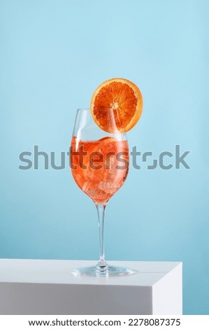 Glass of Aperol spritz cocktail on light blue background Royalty-Free Stock Photo #2278087375