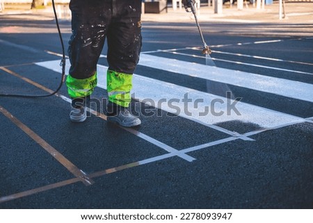 Process of making new road surface markings with a line striping machine, workers improve city infrastructure, demarcation marking of pedestrian crossing with hot melted paint on asphalt pavement
 Royalty-Free Stock Photo #2278093947
