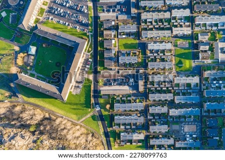 A stunning aerial view of a residential suburb, showcasing the intricate architecture of the built structures in an awe-inspiring birds-eye perspective.