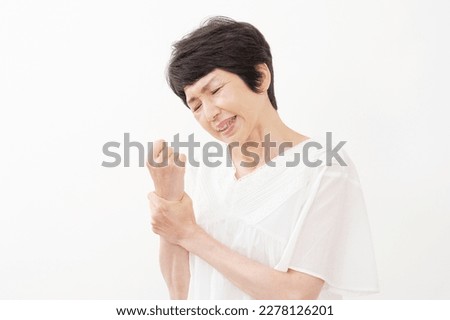 Asian middle aged woman having the joint pain in white background