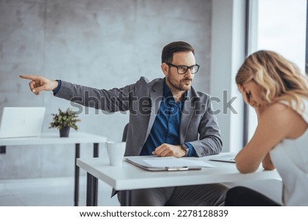 Getting fired. Angry boss pointing female employee on exit way. Last day at work. Mad confident businessman fire unhappy woman worker, dissatisfied with work results. Dismissal concept. Royalty-Free Stock Photo #2278128839