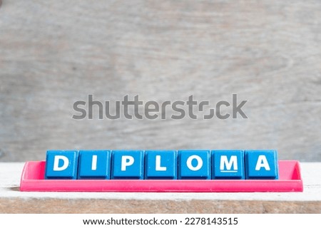 Tile alphabet letter with word diploma in red color rack on wood background Royalty-Free Stock Photo #2278143515