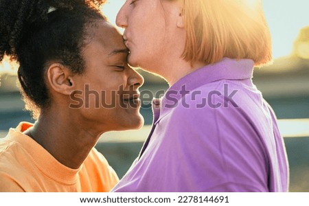 Lesbian couple having tender moments during sunset outdoor - Lgbt and love relationship concept