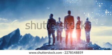 Group of people standing on mountaintop and digital technology concept. Management strategy. Wide angle visual for banners or advertisements.