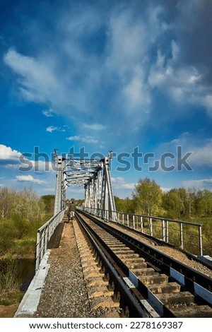 Railway Bridge view. Railroad Path leading into the distance blue sky.