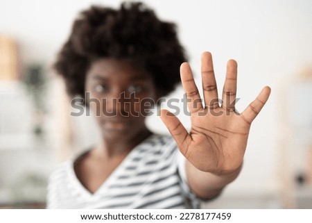 Closeup of african woman's hand making stop sign. Racism, equality and discrimination concept.
