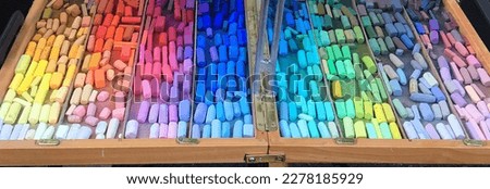 Many shades of colored pastel chalk, ROYGBIV, bright rainbow, landscape.