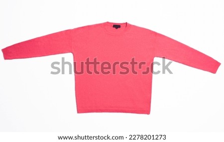 Still life. Studio shot detail of a woman's pink sweater, laid flat