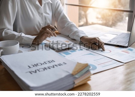 Businesswoman or accountant working on calculator to calculate business data, accountancy document. business concept. close up