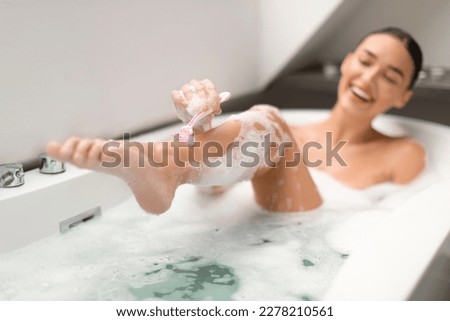 Body Hair Removal. Happy Woman Shaving Legs Using Safety Razor Caring For Herself Bathing In Modern Bathroom At Home. Depilation And Skincare Cosmetics Concept. Selective Focus Royalty-Free Stock Photo #2278210561