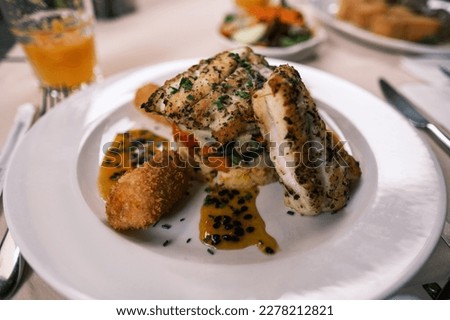 Black Scabbard Fish with Fried Bananas, a traditional delicacy in Madeira Island, Portugal Royalty-Free Stock Photo #2278212821