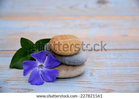 Zen stones on a wooden background with flowers