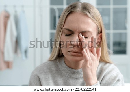 closeup of blonde female feel eye strain or migraine, exhausted young woman worker with headache pain, bad weak blurry vision, eyesight problem Royalty-Free Stock Photo #2278222541