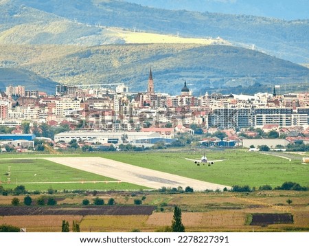 Different view over the city . Dramatic sunlight over the city. Avram Iancu airport runway in Cluj with plane landing. East side view of Cluj Napoca, Romania Royalty-Free Stock Photo #2278227391