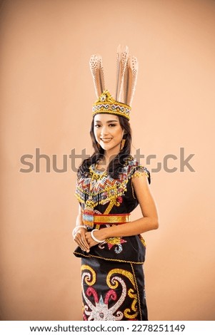 asian woman in king bibinge standing with smile while put her hand in front of her body on isolated background