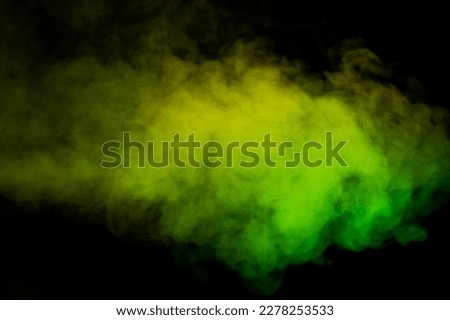 Yellow and green steam on a black background. Copy space.