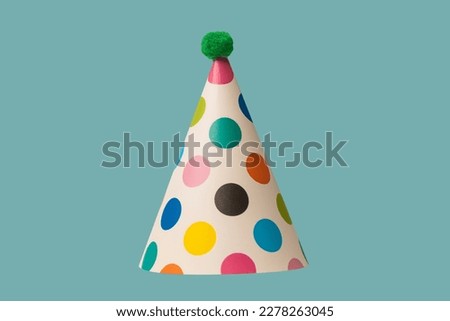 Bright and colorful birthday cap isolated on a green background. Holidays cocept.  Royalty-Free Stock Photo #2278263045