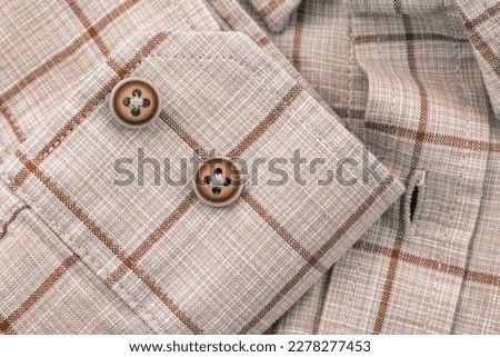 Men's shirt. Plaid shirt sleeve with buttons. Piece of clothing. Button Royalty-Free Stock Photo #2278277453