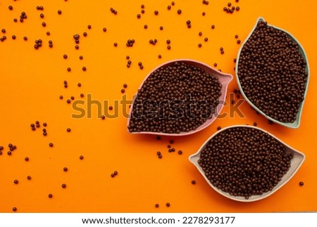 baskets of chocolate balls on an orange background