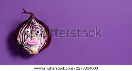 Halloween background. Spooky onion on a purple background. Halloween food. Banner.