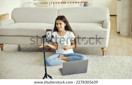 Beautiful preteen 12s girl blogger record video for vlog, talk to subscribers, make call, lead stream with virtual friends use modern tech. Streamer activity, igeneration, fun and home use internet Royalty-Free Stock Photo #2278305639