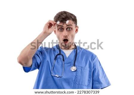 Doctor in uniform and with a stethoscope shows emotions of surprise and horror by opening mouth and raising glasses.