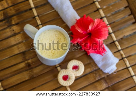 white mug with cappuccino on bamboo table, coffee cup in the morning concept picture
