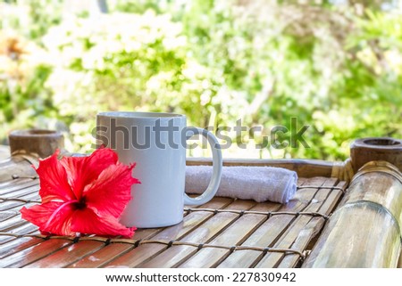 white mug with cappuccino on bamboo table, coffee cup in the morning concept picture