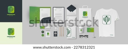 Starter pack for company design include green plant logo in minimalistic style and corporate identity set. Folder A4 and business card, envelope and ID badge, notepad and t-shirt, letterhead and cup Royalty-Free Stock Photo #2278312321