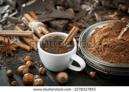 Dark chocolate on the background of cocoa beans and items for the kitchen