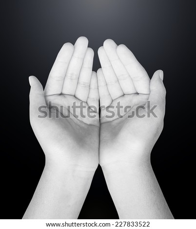 Black and white human hands of prayer.
