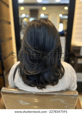 Medium Length Layered Hair Cut Royalty-Free Stock Photo #2278347591