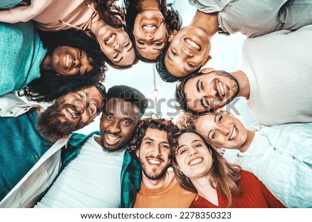 Portrait close up picture of happy faces young friends standing in circle and looking at camera - Millenial diverse people taking selfie photo - Life style concept with guys and girls hugging together