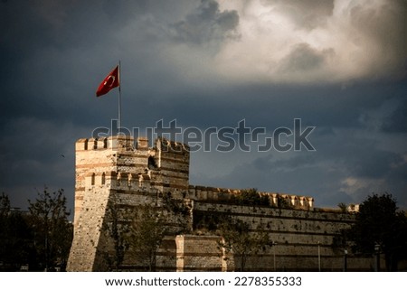 Turkish flag on fortress, turkish flag on top of the stone wall castle istanbul in night, medieval war history background concept, Selective focus, artificial exposure and noise on image