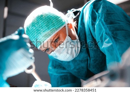 Surgeon focusing on brain surgery in an operating room Royalty-Free Stock Photo #2278358451