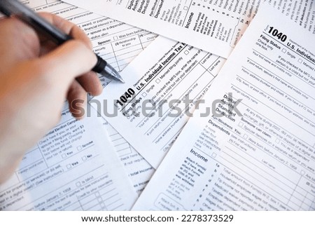Tax paperwork for internal revenue service IRS showing financial accounting 1040 documents showing time for payment and deadline for refund time and declaration of financial debt and profit balance Royalty-Free Stock Photo #2278373529